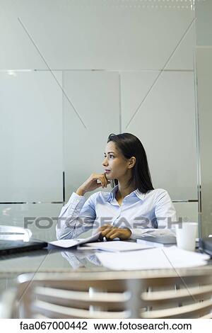 Businesswoman looking away in thought View Large Photo Image Stock Image - Businesswoman looking away in thought. Fotosearch