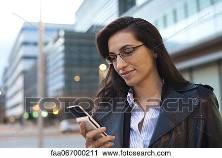 Businesswoman using cell phone, portrait View Large Photo Image Stock Image - Businesswoman using cell phone, portrait. Fotosearch