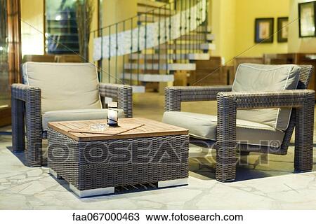 Chairs and coffee table at hotel lobby View Large Photo Image Stock Image - Chairs and coffee table at hotel lobby. Fotosearch