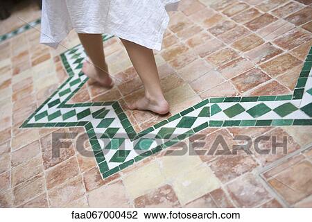 Child walking barefoot on tiled patio, cropped View Large Photo Image Stock Image - Child walking barefoot on tiled patio, cropped. Fotosearch