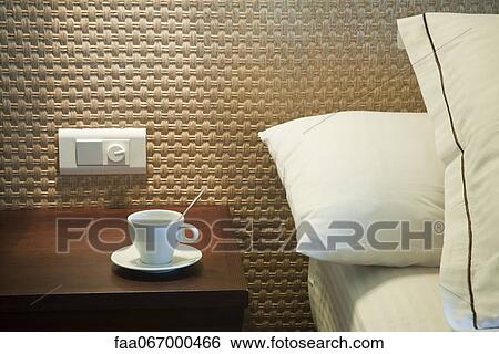 Coffee cup on bedside table View Large Photo Image Stock Photograph - Coffee cup on bedside table. Fotosearch