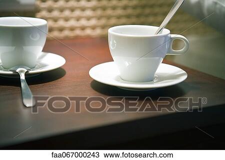 Stock Image - Coffee cups on table. Fotosearch