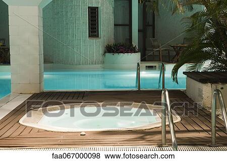 Hot tub and swimming pool in hotel View Large Photo Image Stock Photo - Hot tub and swimming pool in hotel. Fotosearch