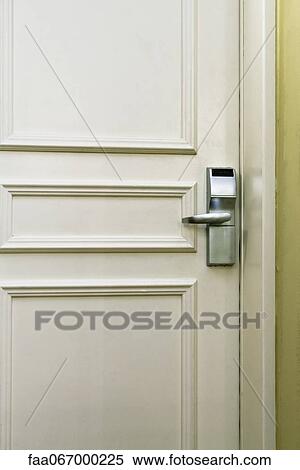 Stock Photography - Hotel room door with electronic door lock, full frame. Fotosearch