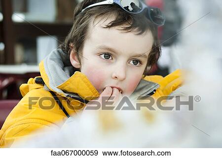 Stock Photo - Little boy eating snack. Fotosearch