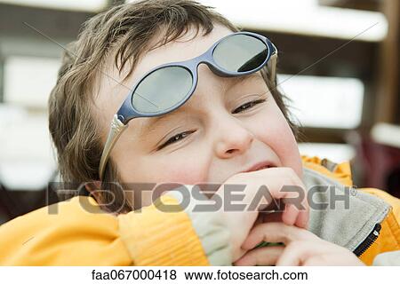Stock Photo - Little boy laughing, portrait. Fotosearch