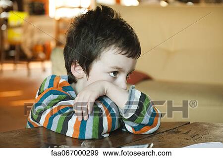 Little boy sulking, resting head on arms View Large Photo Image Stock Photo - Little boy sulking, resting head on arms. Fotosearch