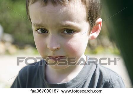 Stock Photo - Little boy with worried look on face, portrait. Fotosearch