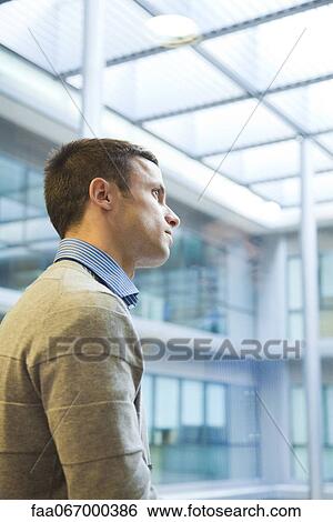 Man looking through window, portrait View Large Photo Image Stock Photograph - Man looking through window, portrait. Fotosearch