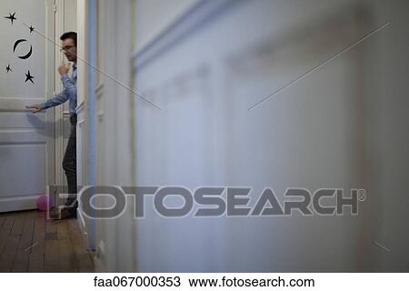 Man walking in hallway View Large Photo Image Stock Image - Man walking in hallway. Fotosearch