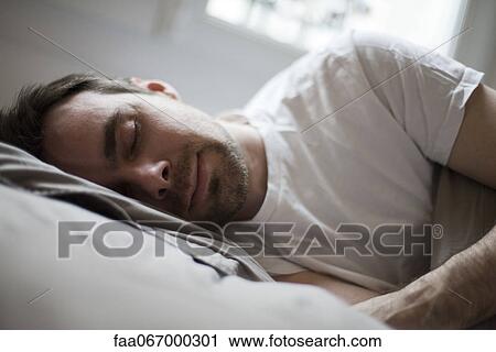 Mid-adult man sleeping View Large Photo Image Stock Image - Mid-adult man sleeping. Fotosearch