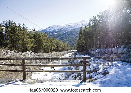 Stock Photo - Snow-covered frozen stream bed. Fotosearch