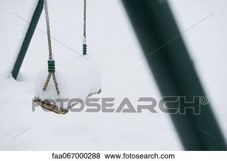 Snow-covered swing View Large Photo Image Stock Photo - Snow-covered swing. Fotosearch