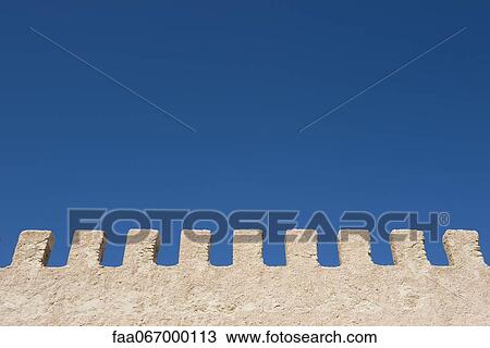 Stock Image - Stucco wall and blue sky. Fotosearch