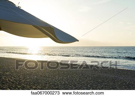 Sunset at beach View Large Photo Image Stock Image - Sunset at beach. Fotosearch