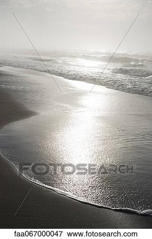 Surf lapping beach View Large Photo Image Stock Photo - Surf lapping beach. Fotosearch