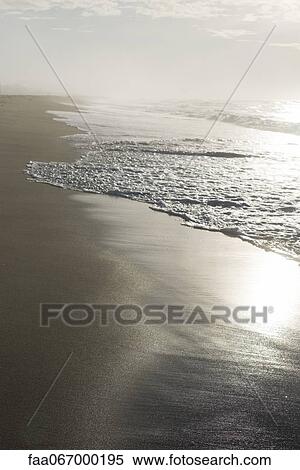 Surf lapping beach View Large Photo Image Stock Photography - Surf lapping beach. Fotosearch