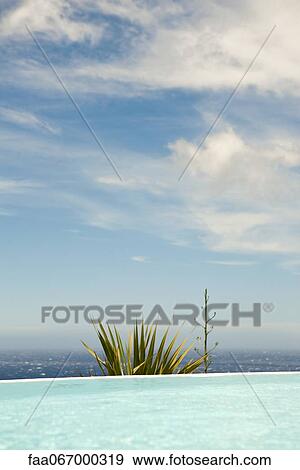 Swimming pool, sea in background View Large Photo Image Stock Photo - Swimming pool, sea in background. Fotosearch