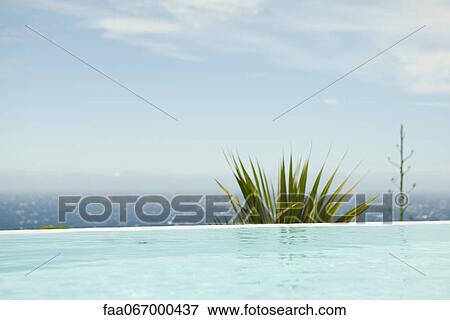 Swimming pool, sea in background View Large Photo Image Stock Photo - Swimming pool, sea in background. Fotosearch