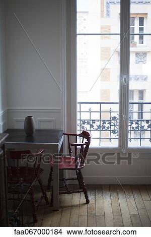 Table and chairs by window View Large Photo Image Picture - Table and chairs by window. Fotosearch