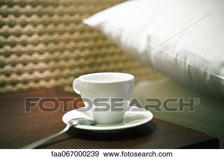 Stock Photo - Tea cup on bedside table. Fotosearch