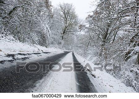 Tire tracks on snow-covered road View Large Photo Image Stock Photo - Tire tracks on snow-covered road. Fotosearch