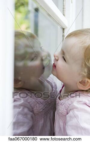 Toddler girl looking through window View Large Photo Image Stock Image - Toddler girl looking through window. Fotosearch