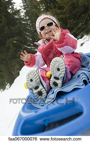 Toddler girl on sled View Large Photo Image Stock Photograph - Toddler girl on sled. Fotosearch