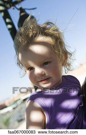 Stock Image - Toddler girl outdoors, portrait. Fotosearch