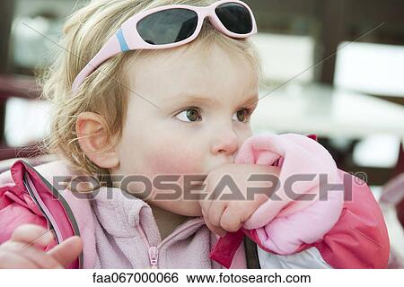 Toddler girl sucking her thumb View Large Photo Image Stock Photograph - Toddler girl sucking her thumb. Fotosearch