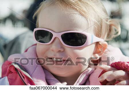 Picture - Toddler girl wearing sunglasses, portrait. Fotosearch
