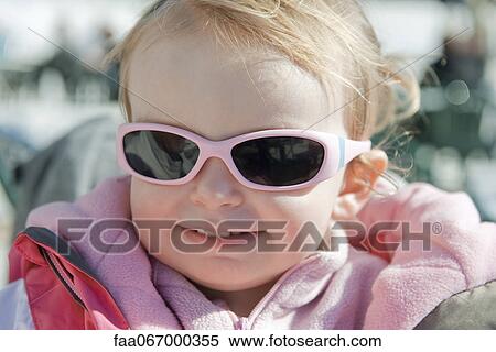 Stock Photography - Toddler girl wearing sunglasses, portrait. Fotosearch