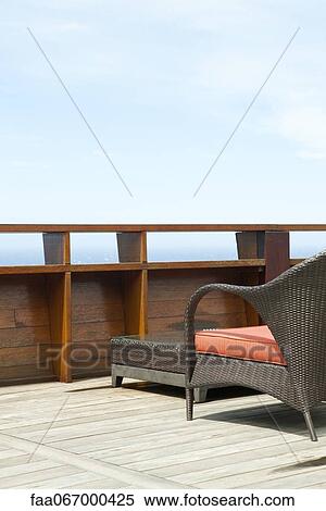 Stock Photography - Wicker patio furniture on deck. Fotosearch