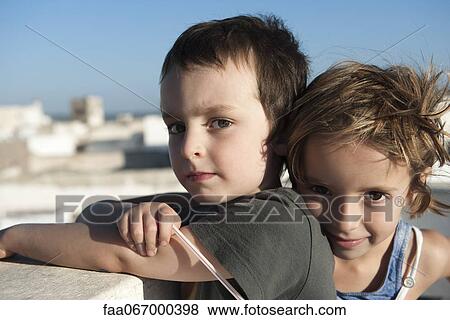 Stock Photo - Young brother and sister, portrait. Fotosearch