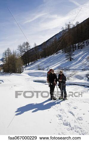 Stock Photo - Young family snowshoeing. Fotosearch
