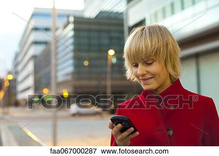Young woman using cell phone, portrait View Large Photo Image Stock Photo - Young woman using cell phone, portrait. Fotosearch