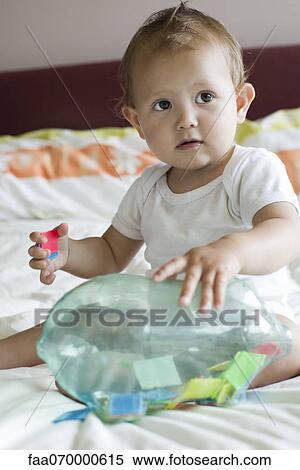 Stock Photography - Baby playing with toy. Fotosearch