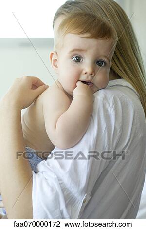 Baby resting head on mother's shoulder, portrait View Large Photo Image Stock Image - Baby resting head on mother's shoulder, portrait. Fotosearch
