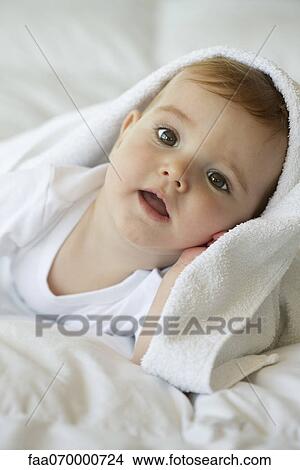 Baby with blanket on head, portrait View Large Photo Image Picture - Baby with blanket on head, portrait. Fotosearch