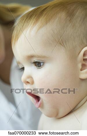 Stock Image - Baby with mouth open in surprise. Fotosearch