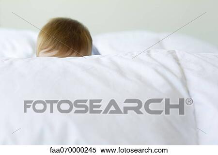 Baby's head visible behind blanket View Large Photo Image Stock Photography - Baby's head visible behind blanket. Fotosearch