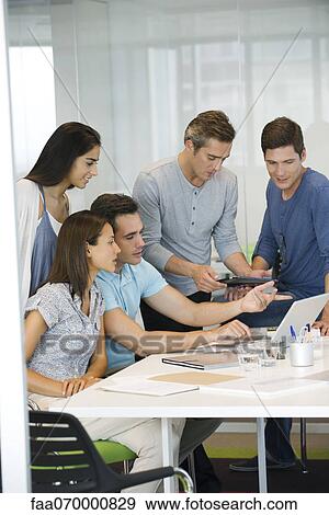 Business associates collaborating in office View Large Photo Image Stock Photo - Business associates collaborating in office. Fotosearch