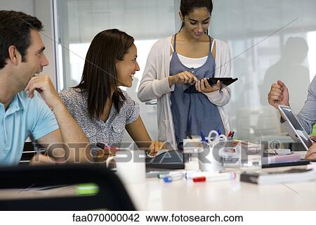 Stock Image - Business associates in casual meeting. Fotosearch