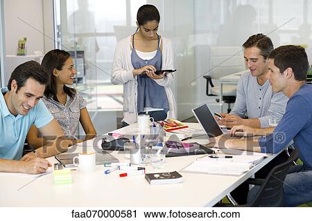 Business associates in casual meeting View Large Photo Image Stock Image - Business associates in casual meeting. Fotosearch