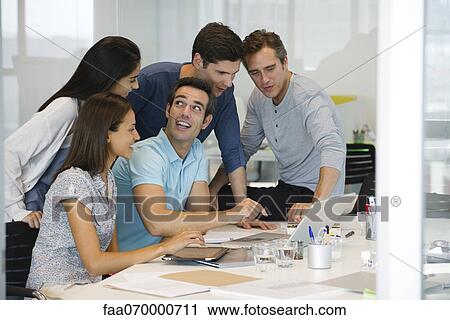 Stock Image - Business associates in casual meeting. Fotosearch