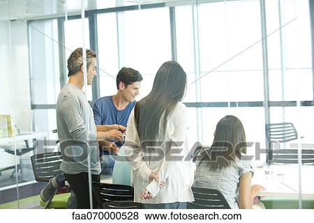 Stock Photo - Business associates in casual meeting. Fotosearch