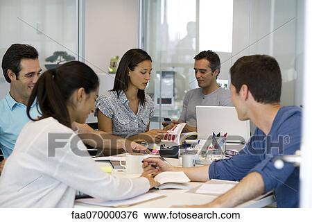 Business associates in casual meeting View Large Photo Image Stock Photograph - Business associates in casual meeting. Fotosearch