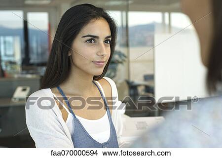 Picture - Casually dressed woman in office. Fotosearch