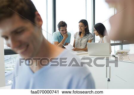 Colleagues collaborating in office View Large Photo Image Stock Image - Colleagues collaborating in office. Fotosearch
