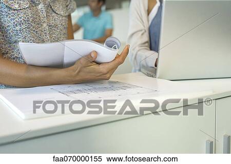 Stock Photography - Colleagues working together, cropped. Fotosearch